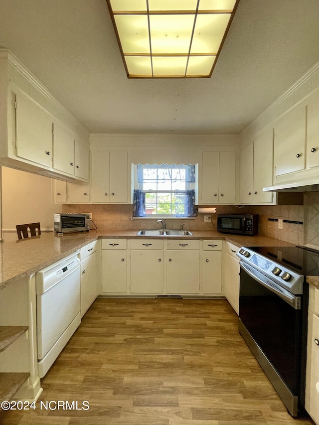 kitchen with black microwave, white dishwasher, a sink, electric stove, and light wood-type flooring