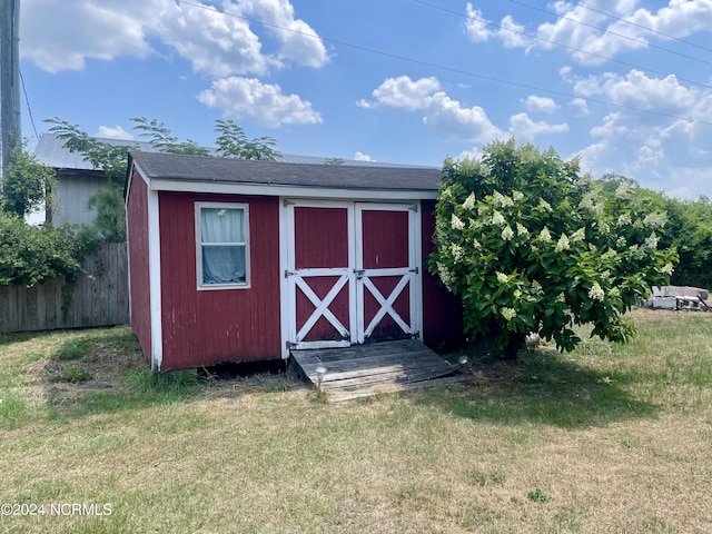 view of shed with fence