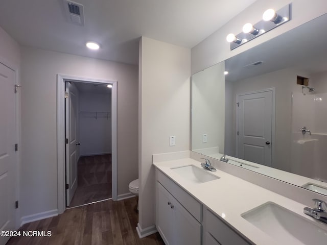 bathroom featuring vanity, toilet, and hardwood / wood-style flooring