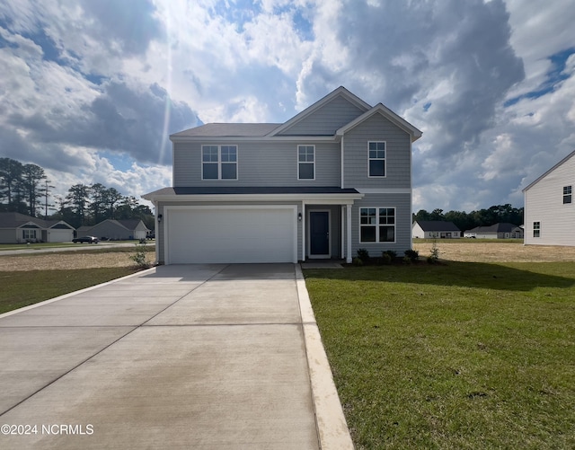 view of property featuring a front yard and a garage