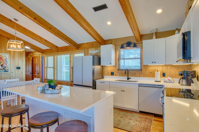 kitchen with dishwasher, a center island, white cabinets, white refrigerator, and sink