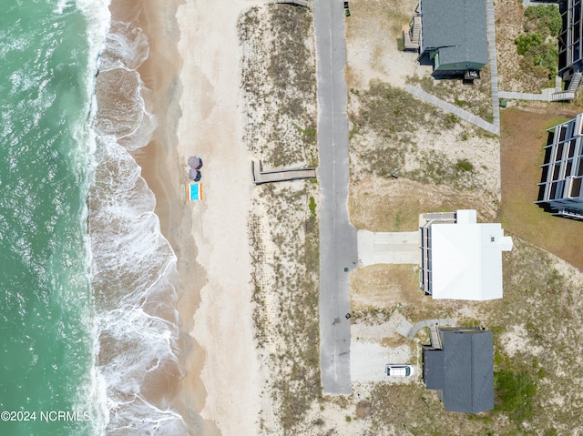 bird's eye view with a water view and a view of the beach