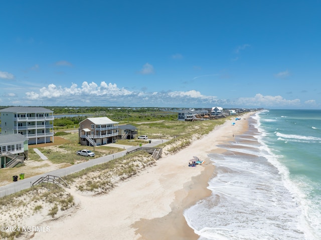 bird's eye view featuring a water view and a view of the beach