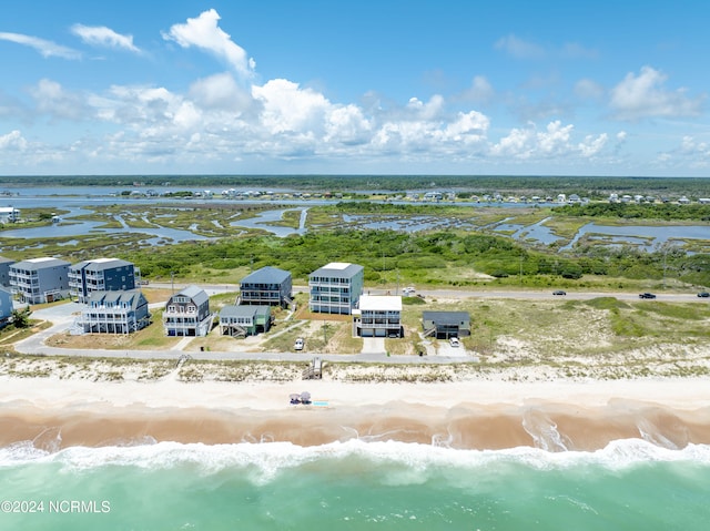 birds eye view of property featuring a beach view and a water view