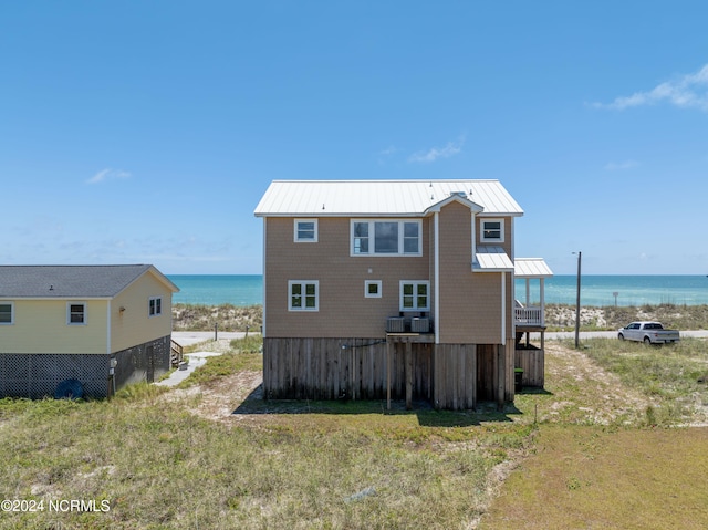 rear view of property with a water view