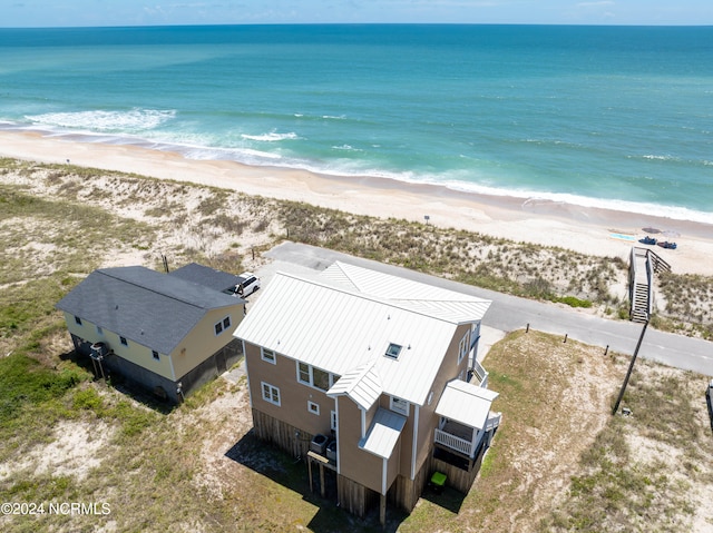 drone / aerial view featuring a view of the beach and a water view