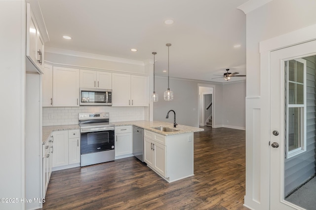 kitchen with ceiling fan, kitchen peninsula, decorative light fixtures, white cabinets, and appliances with stainless steel finishes