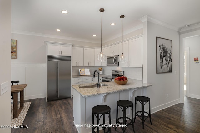 198 Ruskin Dr, Smithfield, NC 27577 - kitchen featuring appliances with stainless steel finishes, light stone counters, white cabinets, sink, and kitchen peninsula