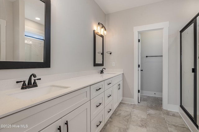 bathroom featuring vanity and an enclosed shower