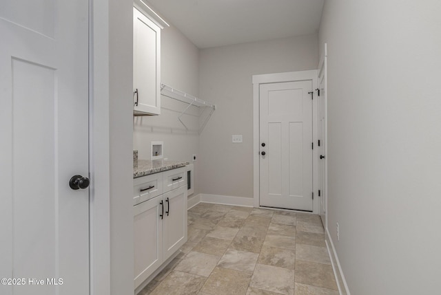 washroom with hookup for an electric dryer, washer hookup, and cabinets