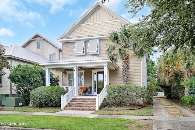 view of front of house with a front yard and a porch