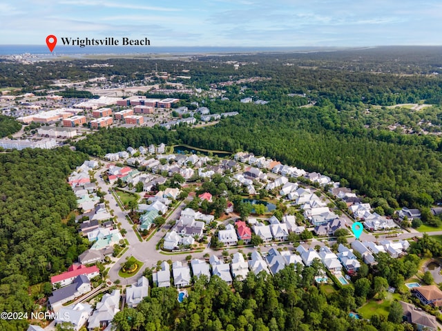 drone / aerial view with a residential view and a wooded view