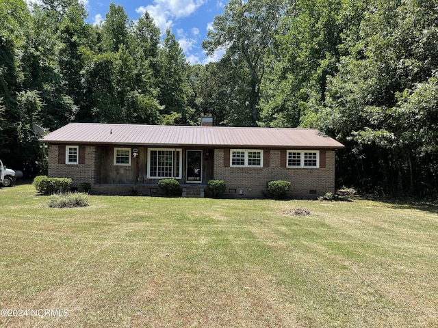 ranch-style home featuring a chimney, brick siding, crawl space, and a front yard