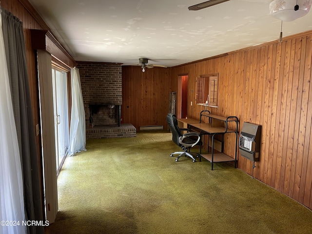 office area with heating unit, baseboard heating, carpet flooring, wood walls, and a fireplace