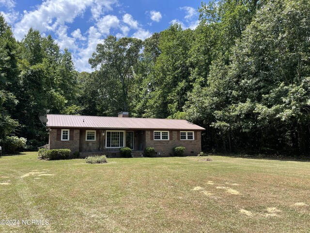 single story home with brick siding, a chimney, crawl space, metal roof, and a front lawn