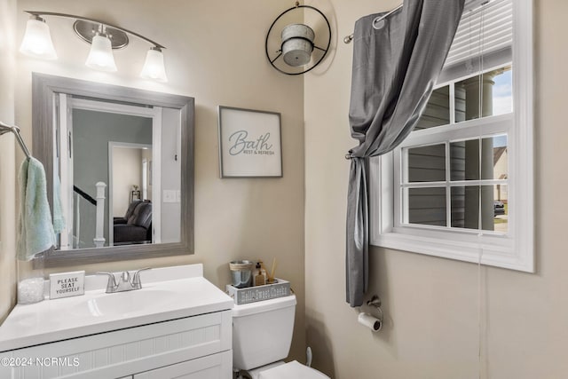 bathroom with toilet and vanity