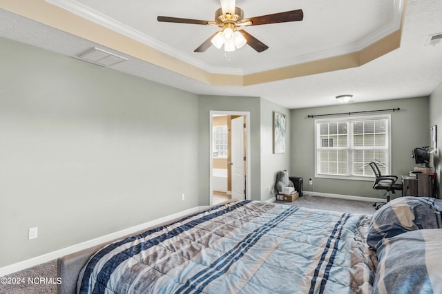 carpeted bedroom featuring ceiling fan, ornamental molding, and a raised ceiling