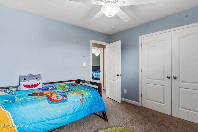 carpeted bedroom featuring ceiling fan and a closet