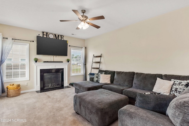 living room with ceiling fan and carpet