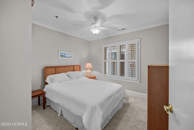 carpeted bedroom with crown molding and ceiling fan