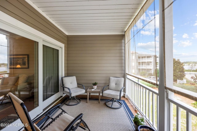 sunroom / solarium featuring wooden ceiling