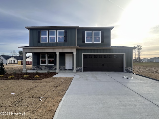 view of front of property with covered porch and a garage