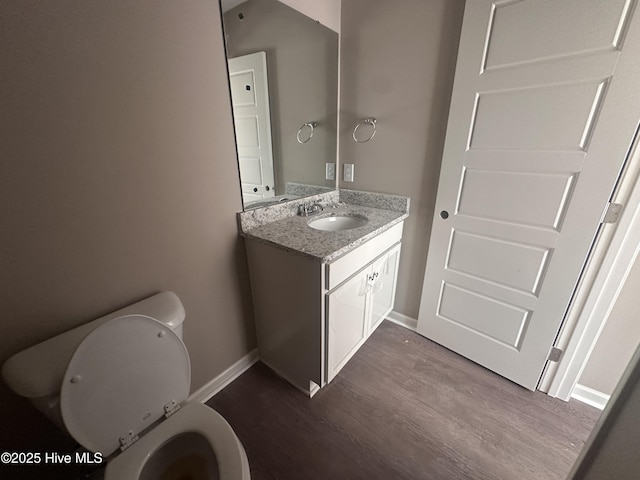 bathroom featuring hardwood / wood-style floors, toilet, and vanity