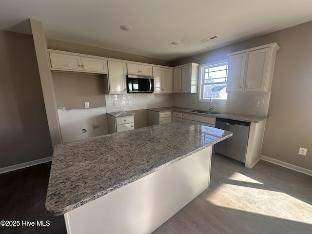 kitchen with sink, white cabinetry, appliances with stainless steel finishes, and a kitchen island