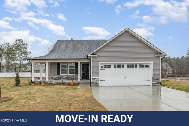 view of front of home with a porch and a garage