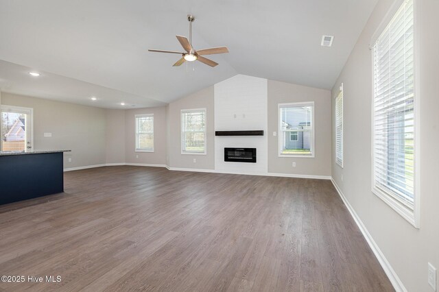 kitchen featuring dishwasher, a center island, white cabinetry, dark hardwood / wood-style flooring, and dark stone counters