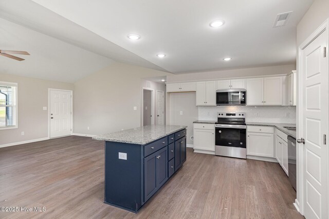 full bathroom with hardwood / wood-style floors, toilet, vanity, and bathing tub / shower combination