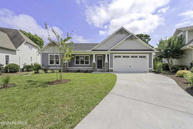 craftsman-style house with an attached garage, driveway, and a front lawn