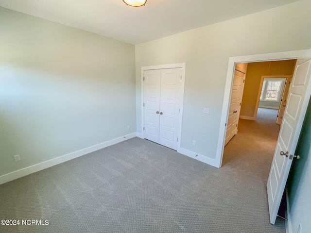 unfurnished bedroom featuring a closet and carpet flooring