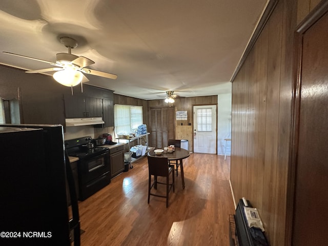 kitchen with ceiling fan, black range with electric stovetop, wood finished floors, and under cabinet range hood