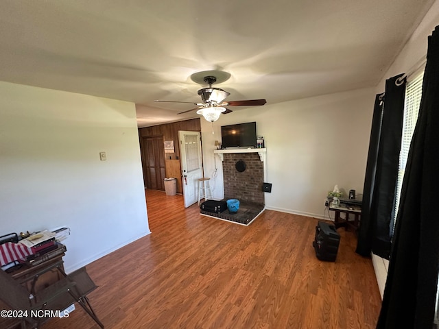 living room featuring wood-type flooring and ceiling fan