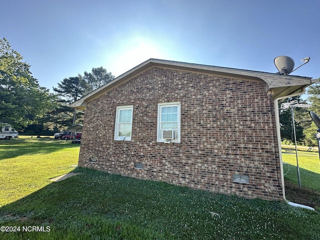 view of home's exterior with crawl space, brick siding, and a yard