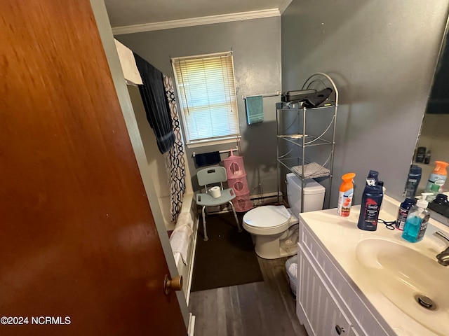 bathroom featuring hardwood / wood-style flooring, ornamental molding, vanity, and toilet