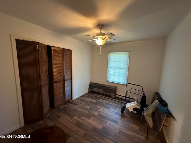 sitting room featuring dark hardwood / wood-style floors and ceiling fan