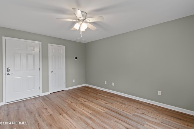 unfurnished bedroom with ceiling fan and light wood-type flooring