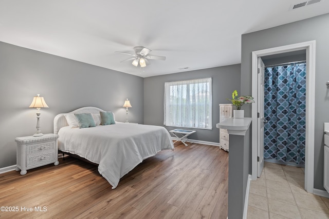 bedroom featuring baseboards, light wood-style floors, and ceiling fan