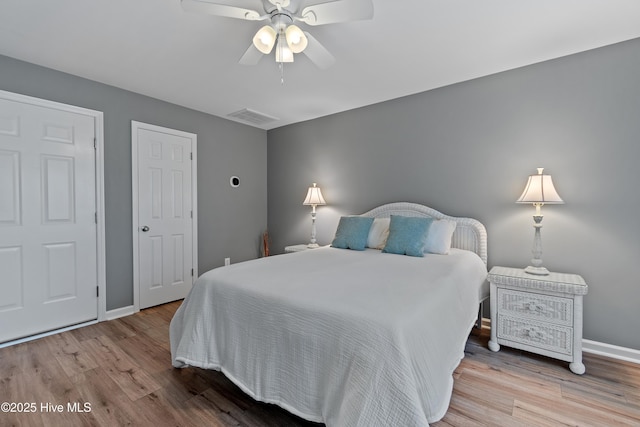 bedroom with wood finished floors, baseboards, and a ceiling fan