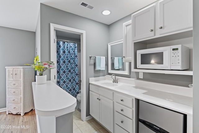 full bathroom with toilet, vanity, baseboards, and a shower with curtain