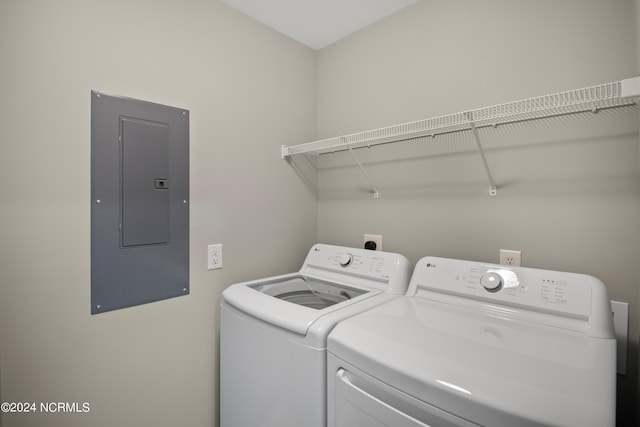 washroom featuring electric panel and washer and dryer