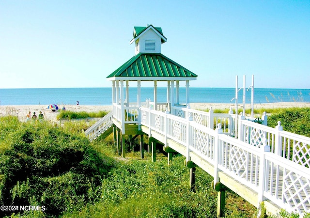 view of property's community with view of water and beach