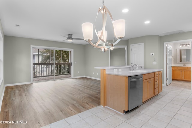 kitchen featuring hanging light fixtures, stainless steel dishwasher, an island with sink, ceiling fan with notable chandelier, and light wood-type flooring