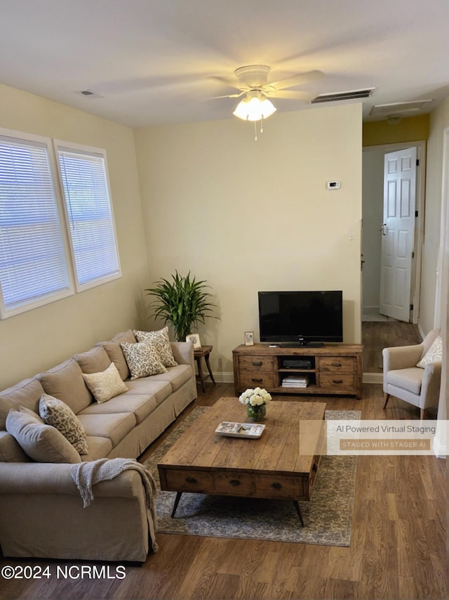 living room featuring ceiling fan and dark wood-type flooring