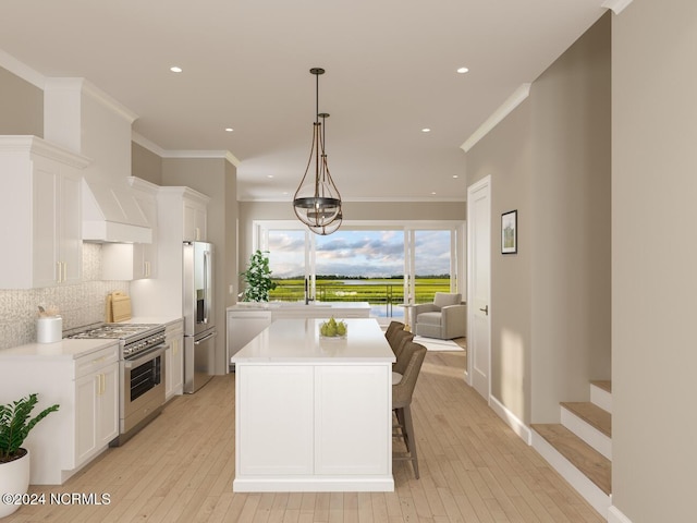 kitchen with pendant lighting, light hardwood / wood-style flooring, white cabinetry, stainless steel appliances, and decorative backsplash