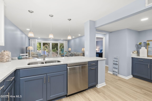 331 Salter Path Rd Unit 104, Pine Knoll Shores, NC 28512 - kitchen with stainless steel dishwasher, a sink, open floor plan, light countertops, and light wood-type flooring