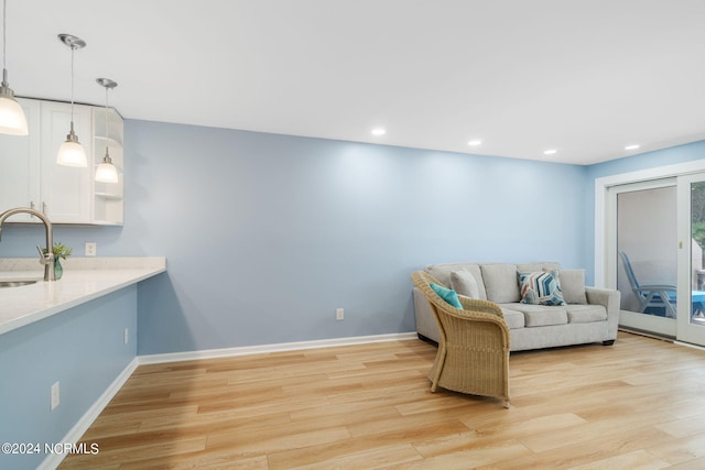 living room with sink and light wood-type flooring