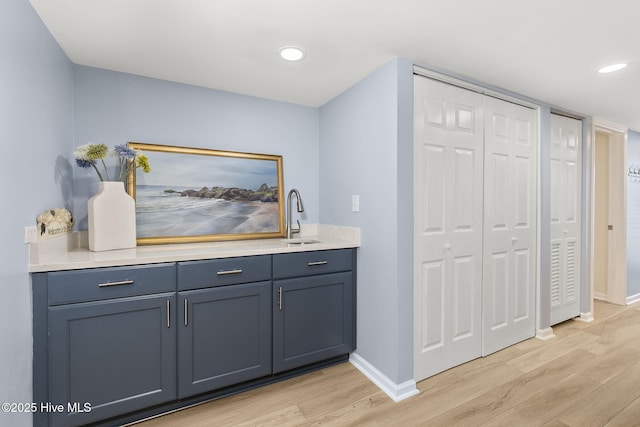 331 Salter Path Rd Unit 104, Pine Knoll Shores, NC 28512 - bar area featuring light wood-type flooring, baseboards, a sink, and recessed lighting